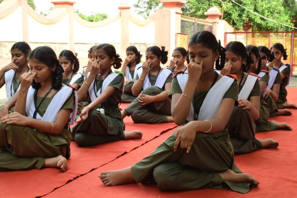 Students practicing pranayama outdoors